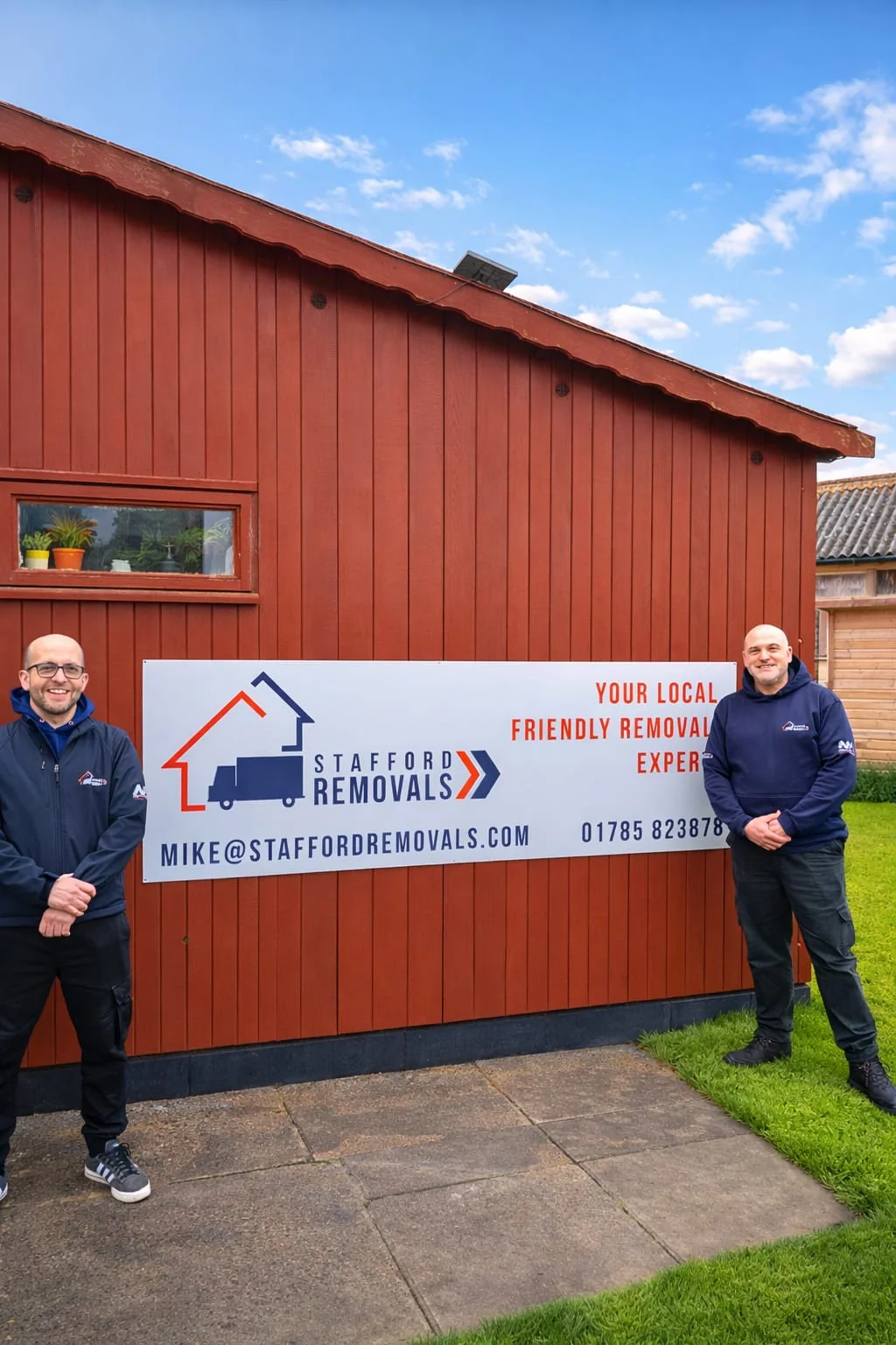 Mike and Chris, who run Stafford Removals, by the company sign