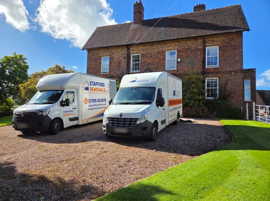 Two Stafford Removals vans outside a house